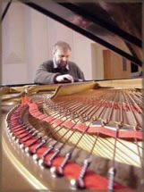 Piano tuner at the grand piano
